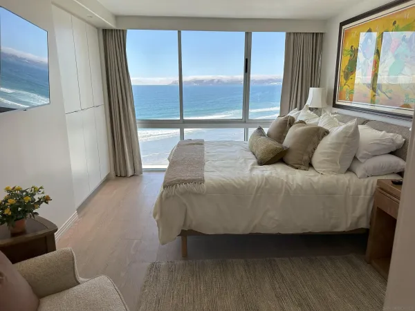 a living room with furniture and large windows