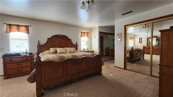 a view of a hallway with furniture and windows