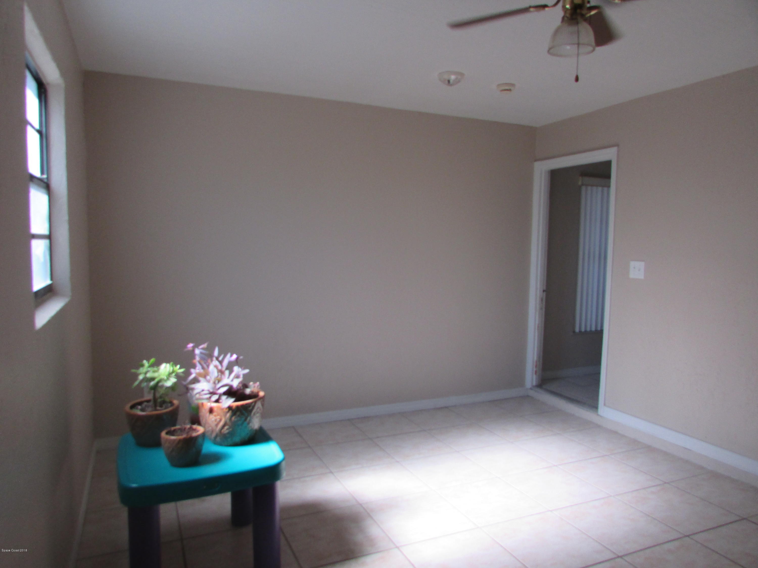 571 Degroodt Road Southwest Palm Bay, FL 32908 - Photo 8 of 12 ENCLOSED GARAGE/ 4TH BEDROOM