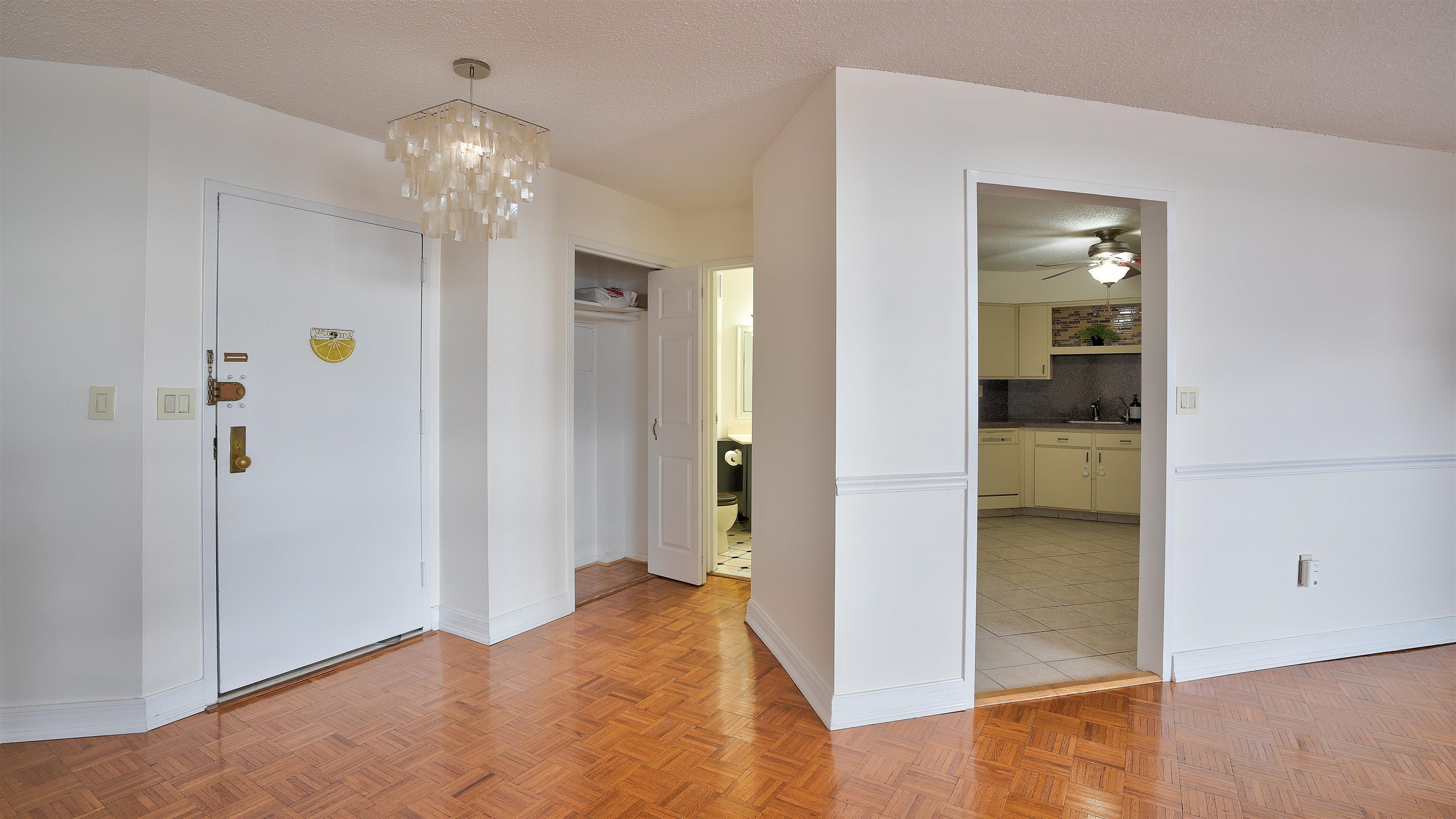720 Harmon Cove Tower, Unit 720 Secaucus, NJ 07094 - Photo 16 of 49 wooden floor in a hall with an entryway and a livingroom