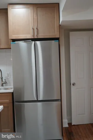 a white refrigerator freezer sitting in a kitchen