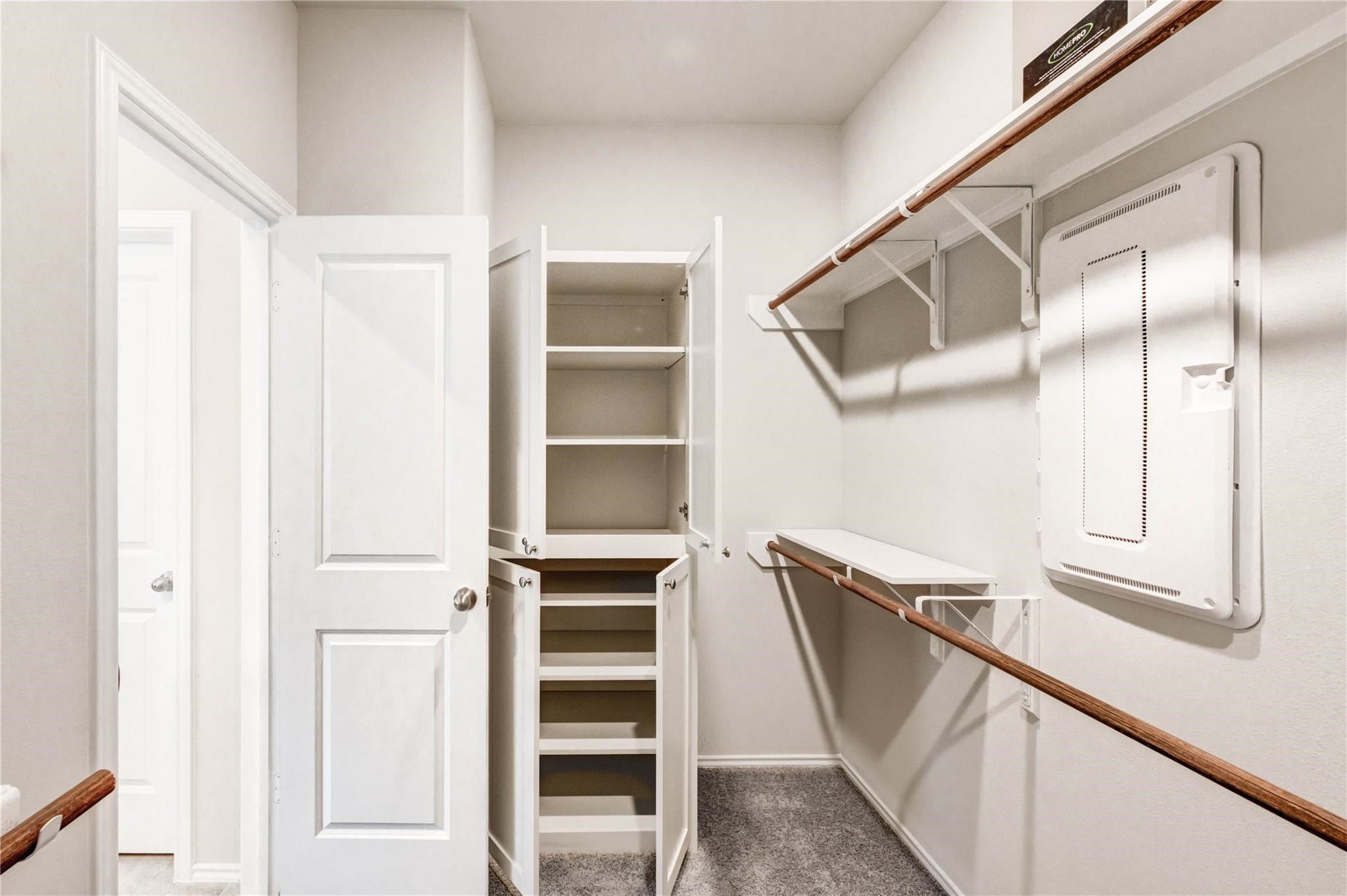 4806 Cedar Butte Lane Manvel, TX 77578 - Photo 10 of 18 This is a spacious walk-in closet featuring white cabinetry and shelving for ample storage, with a carpeted floor for added comfort available