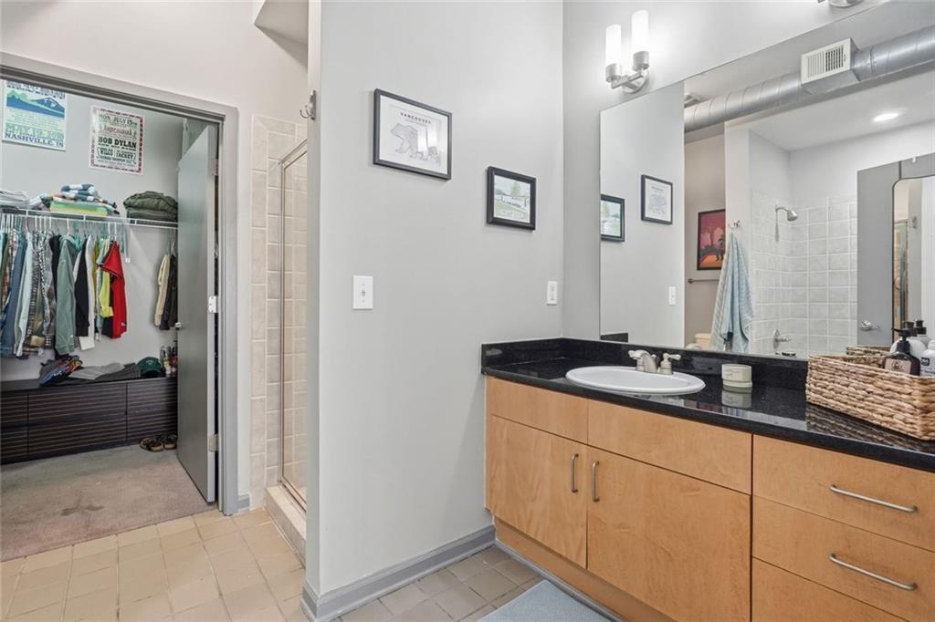5300 Peachtree Road, Unit 2604 Atlanta, GA 30341 - Photo 19 of 39 a en suite bathroom with double sink and a mirror