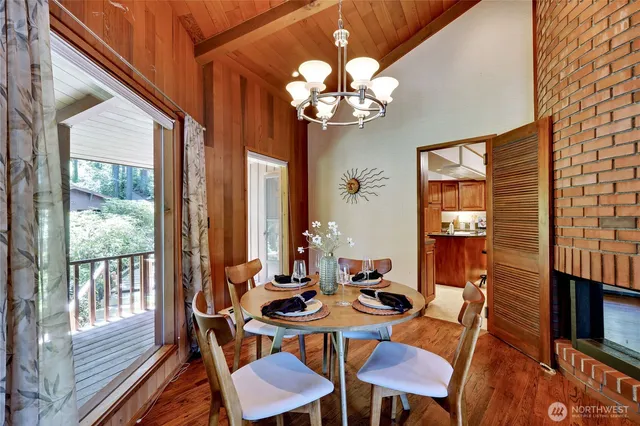 a view of a dining room with furniture a chandelier and wooden floor