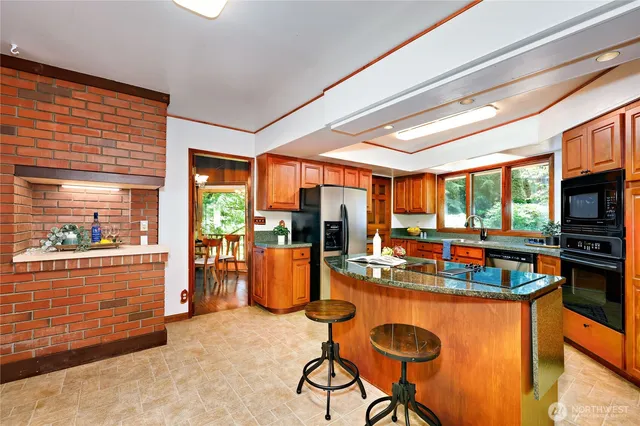a dining room with furniture a large window and a fireplace