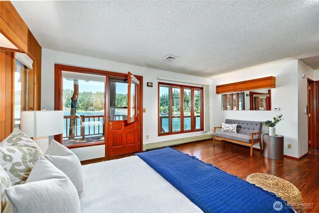 a bedroom with furniture and a large window