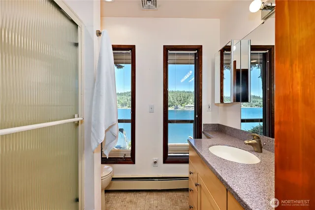 a bathroom with sinks granite countertop tub and a sink