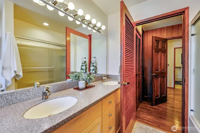 a bathroom with a granite countertop sink and a mirror