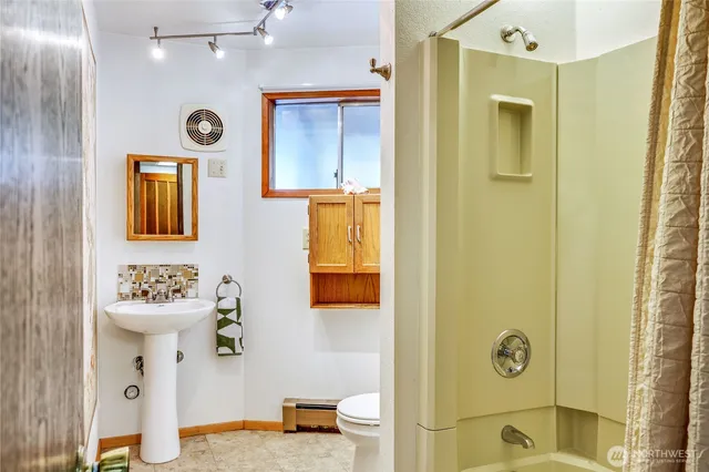 a bathroom with a sink mirror and a shower
