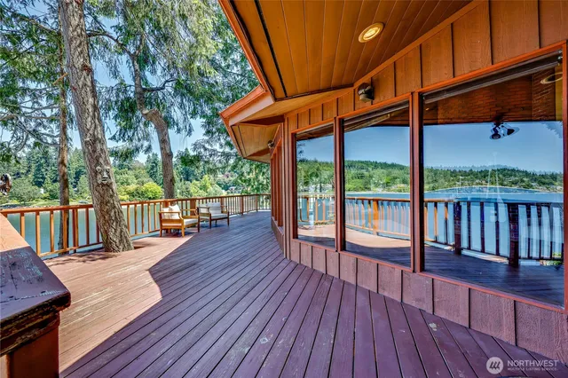 a balcony with wooden floor and wooden fence