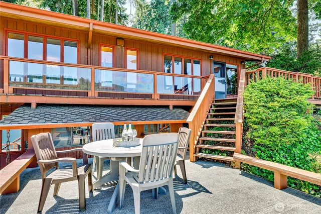 a balcony with table and chairs