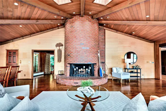 a living room with fireplace furniture and a wooden floor