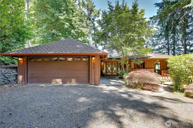 a view of a house with a yard and garage