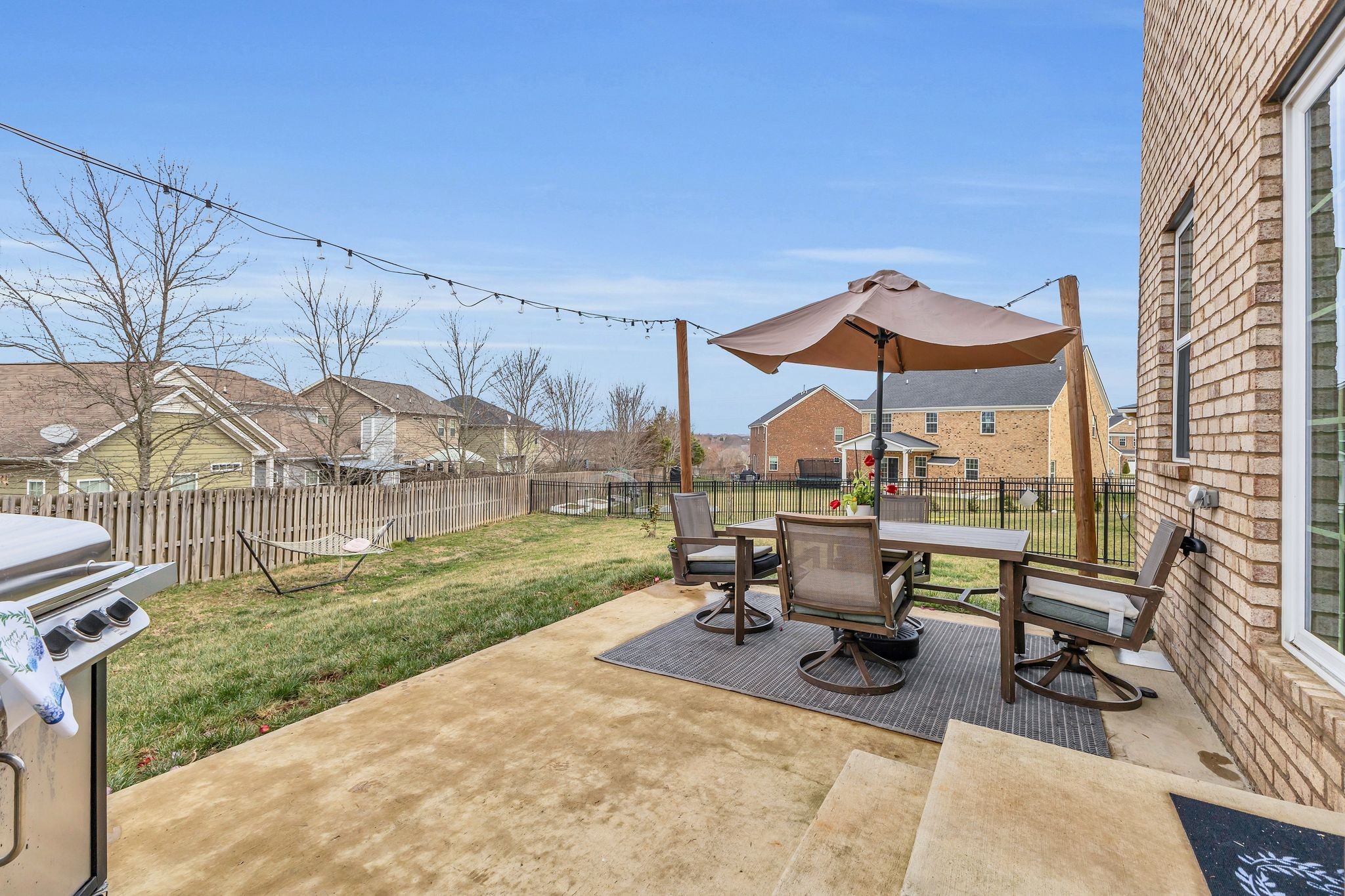 308 Finnegan Ct Spring Hill Spring Hill, TN 37174 - Photo 30 of 35 a view of a patio with a table and chairs under an umbrella