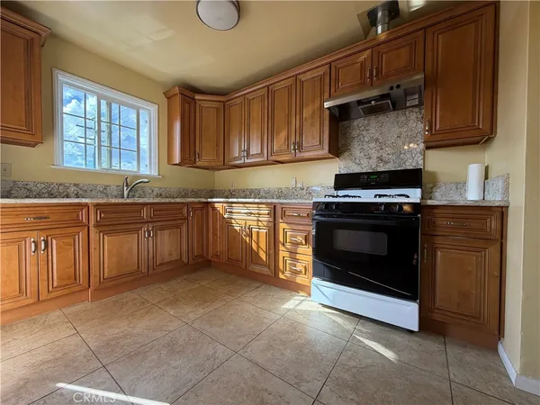 a kitchen with a stove top oven sink and cabinets
