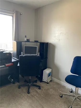 a workspace with furniture and a window