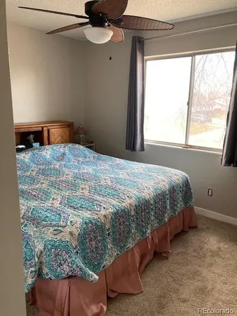 a bedroom with a bed dresser and a window