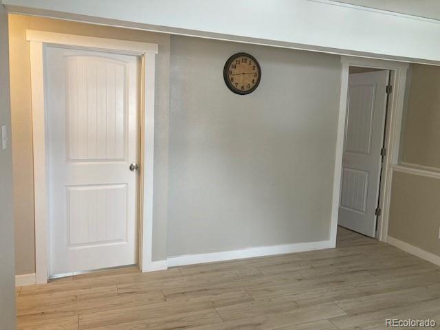 102 Third Street Berthoud, CO 80513 - Photo 19 of 35 a view of a hallway with wooden floor
