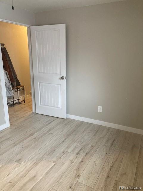 102 Third Street Berthoud, CO 80513 - Photo 28 of 35 a view of an empty room with wooden floor