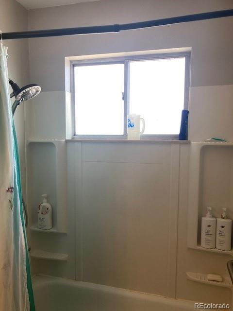 102 Third Street Berthoud, CO 80513 - Photo 31 of 35 a bathroom with a window shower and vanity