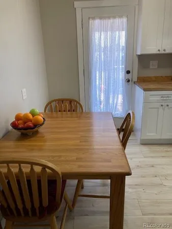 a dining table with chairs and wooden floor
