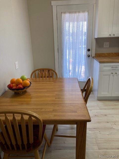 102 Third Street Berthoud, CO 80513 - Photo 5 of 35 a dining table with chairs and wooden floor