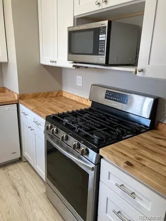 a stove top oven sitting inside of a kitchen