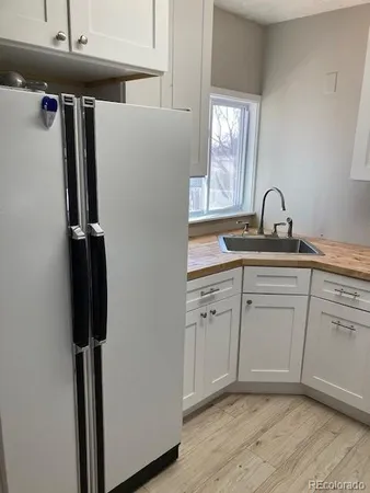 a view of a kitchen with a sink staircase and a window