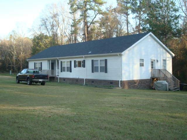 1136 Henry Futch Road Pembroke, GA 31321 - Photo 1 of 1 a view of a house with a backyard