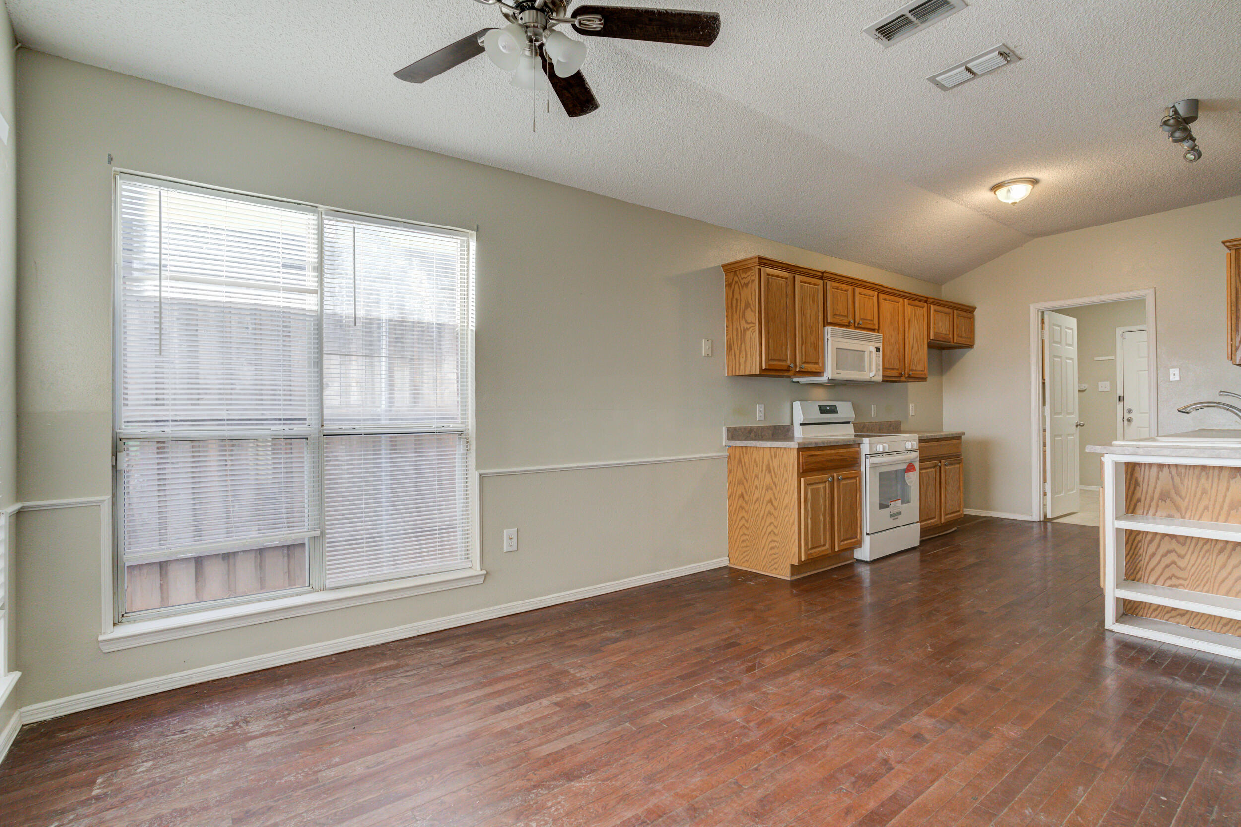 6221 18th Street Lubbock, TX 79416 - Photo 14 of 48 a kitchen with a stove a sink and a refrigerator