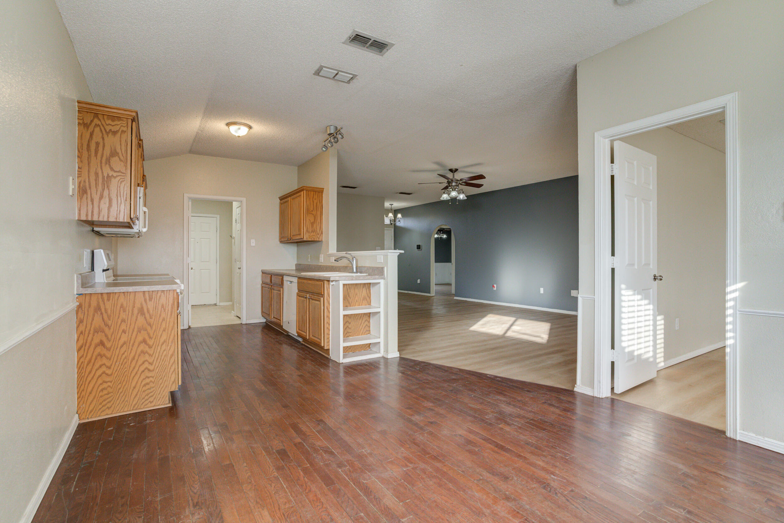 6221 18th Street Lubbock, TX 79416 - Photo 16 of 48 a view of a kitchen with furniture and wooden floor
