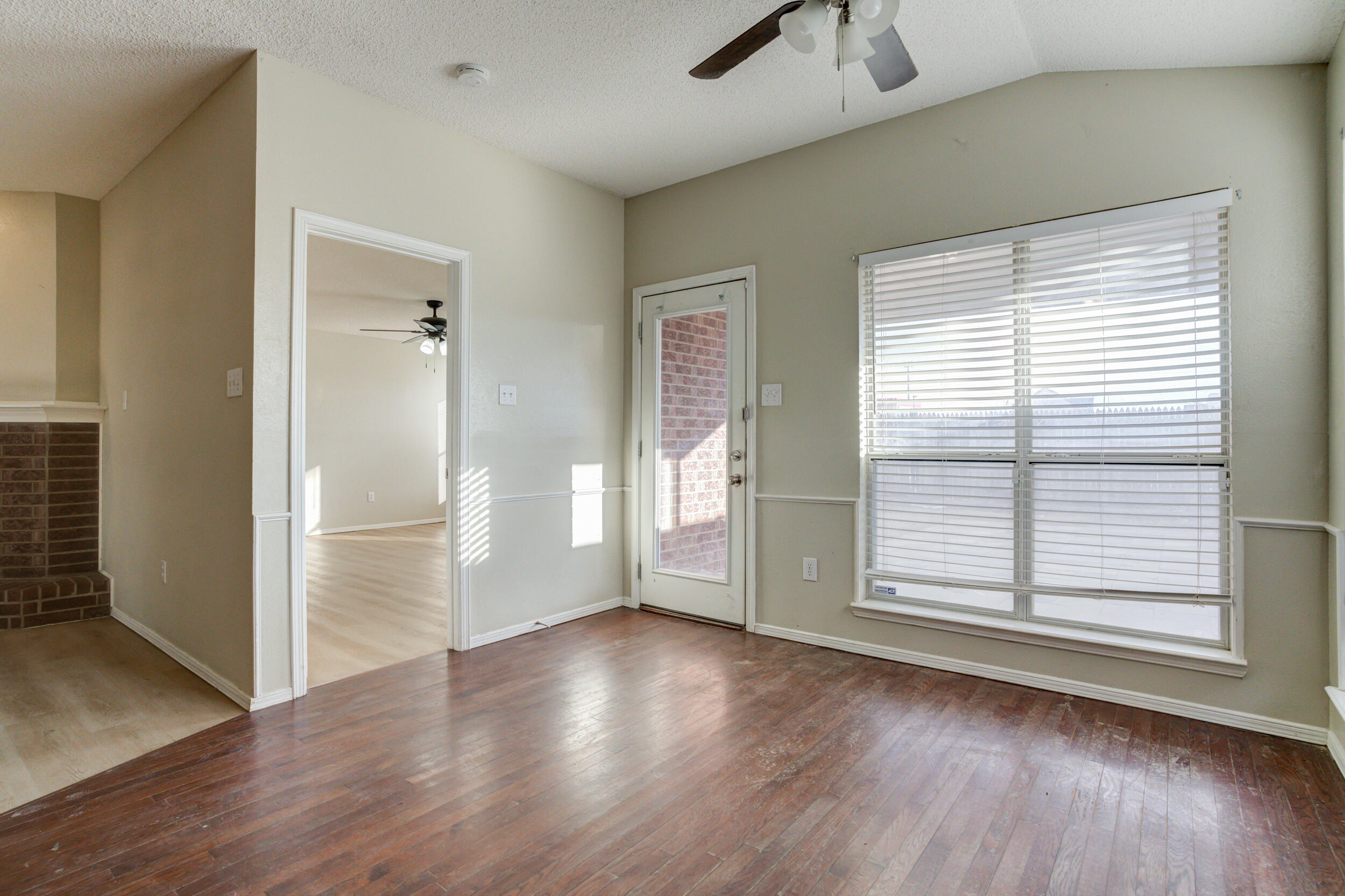 6221 18th Street Lubbock, TX 79416 - Photo 17 of 48 an empty room with wooden floor and windows
