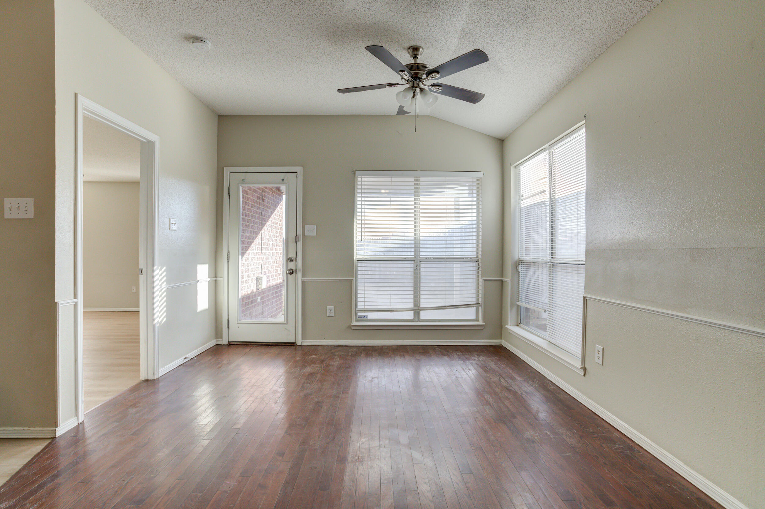 6221 18th Street Lubbock, TX 79416 - Photo 18 of 48 wooden floor in an empty room with a window