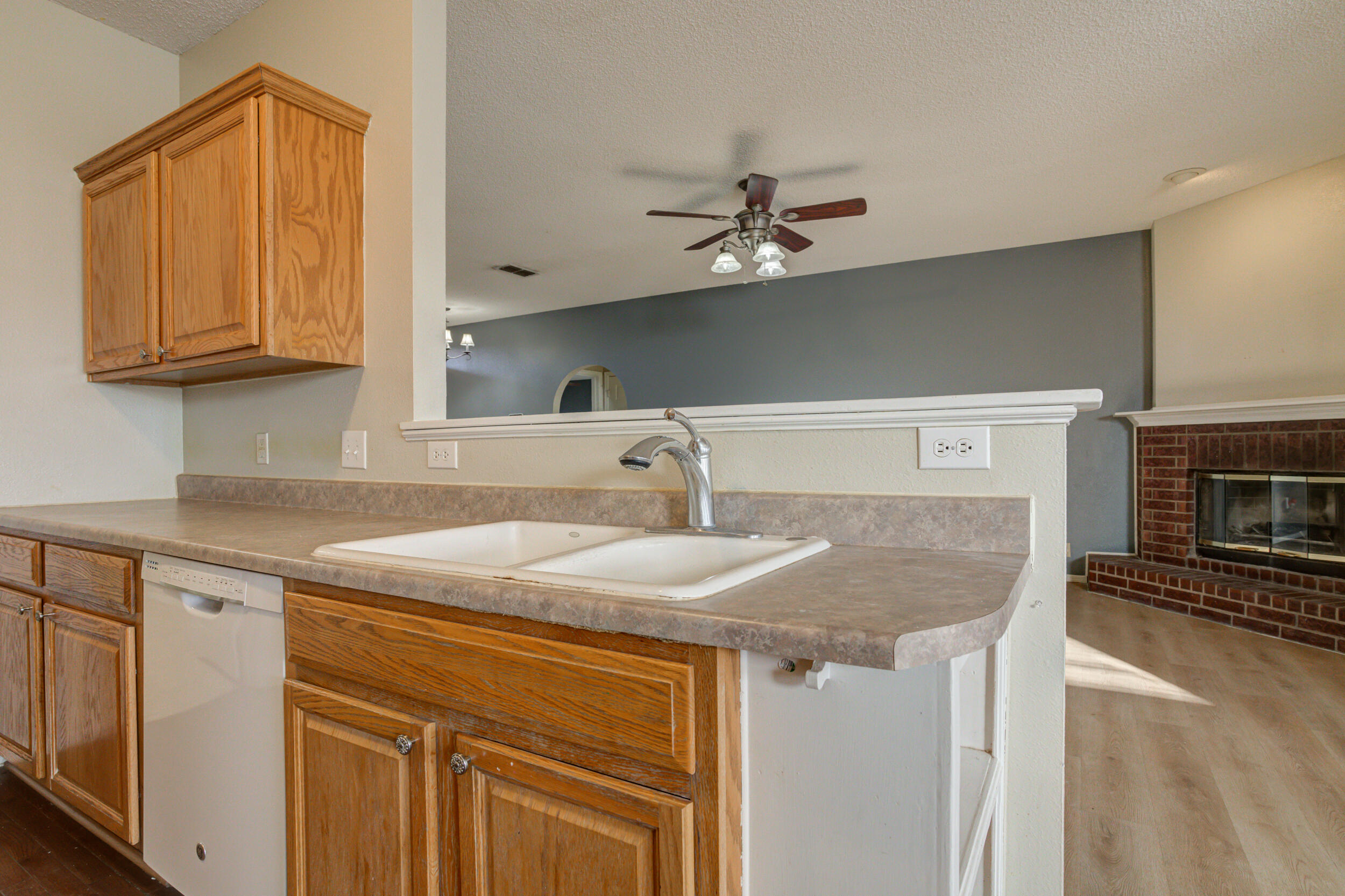 6221 18th Street Lubbock, TX 79416 - Photo 19 of 48 a kitchen with stainless steel appliances granite countertop a sink and dishwasher with white cabinets