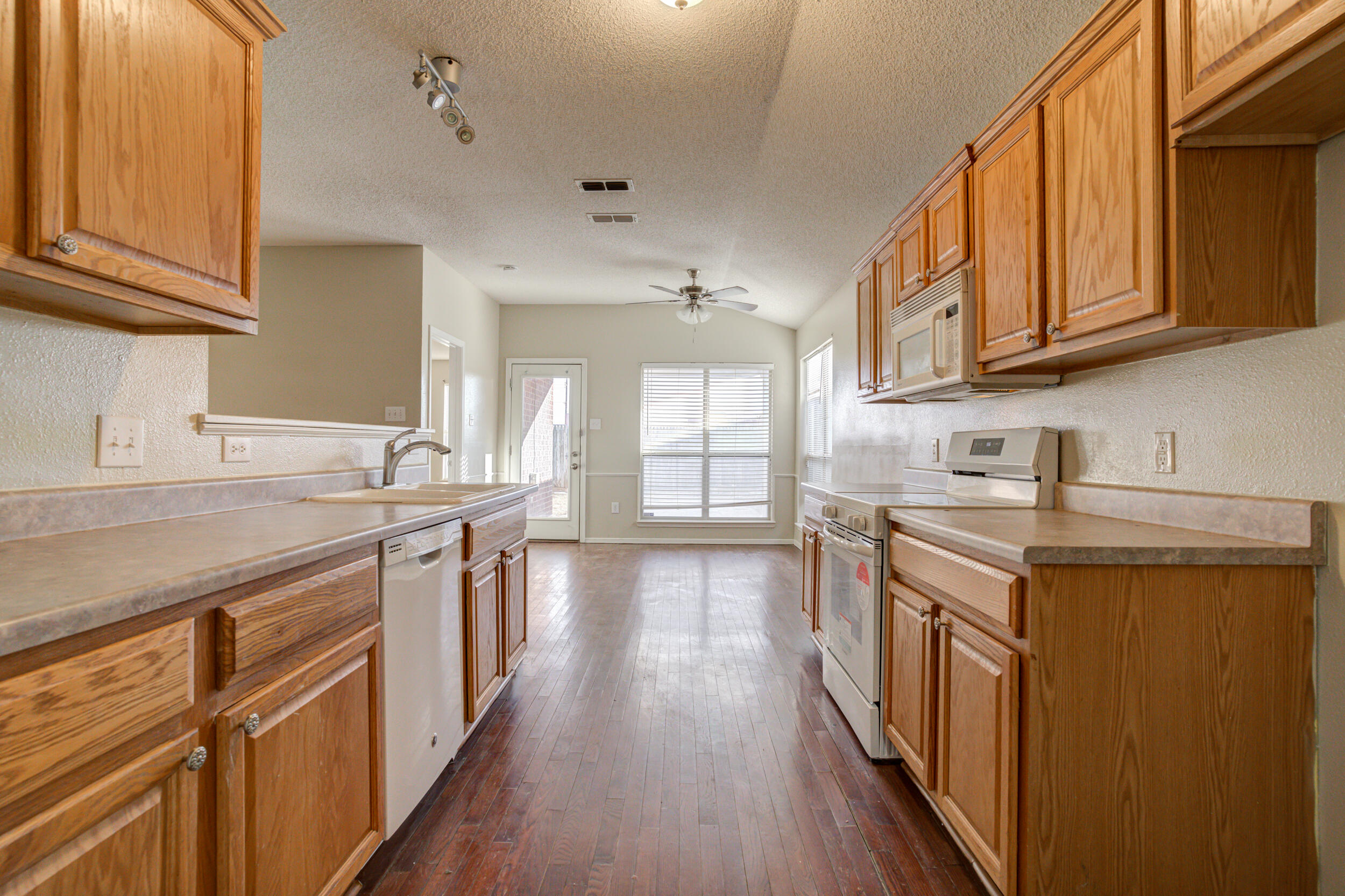 6221 18th Street Lubbock, TX 79416 - Photo 24 of 48 a kitchen with stainless steel appliances granite countertop a stove and cabinets