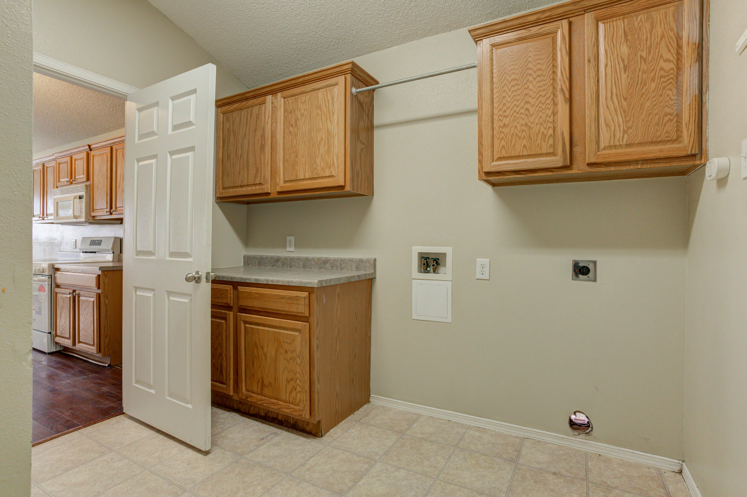 6221 18th Street Lubbock, TX 79416 - Photo 26 of 48 a kitchen with stainless steel appliances granite countertop a refrigerator and cabinets