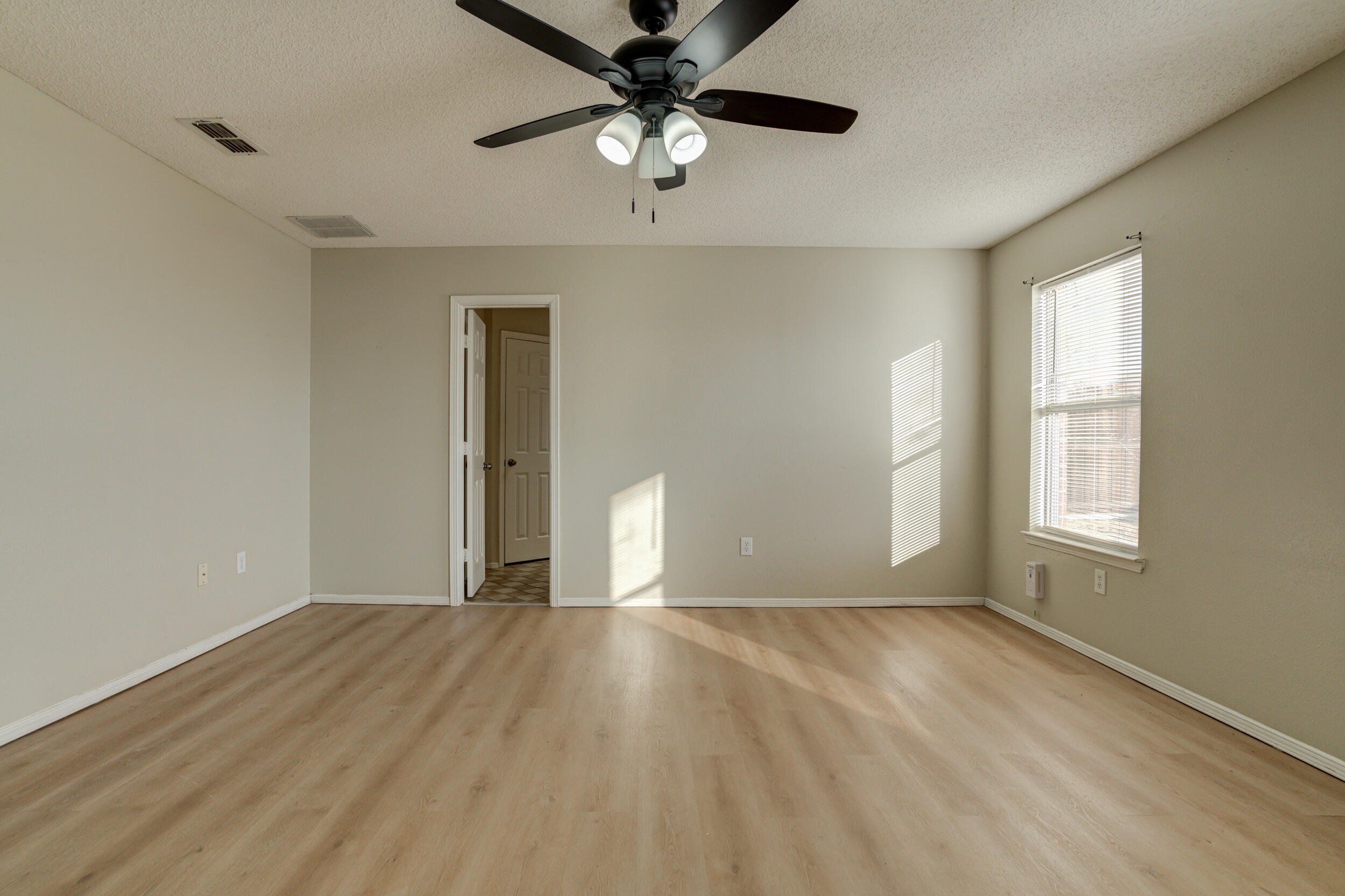 6221 18th Street Lubbock, TX 79416 - Photo 28 of 48 wooden floor in an empty room with a window