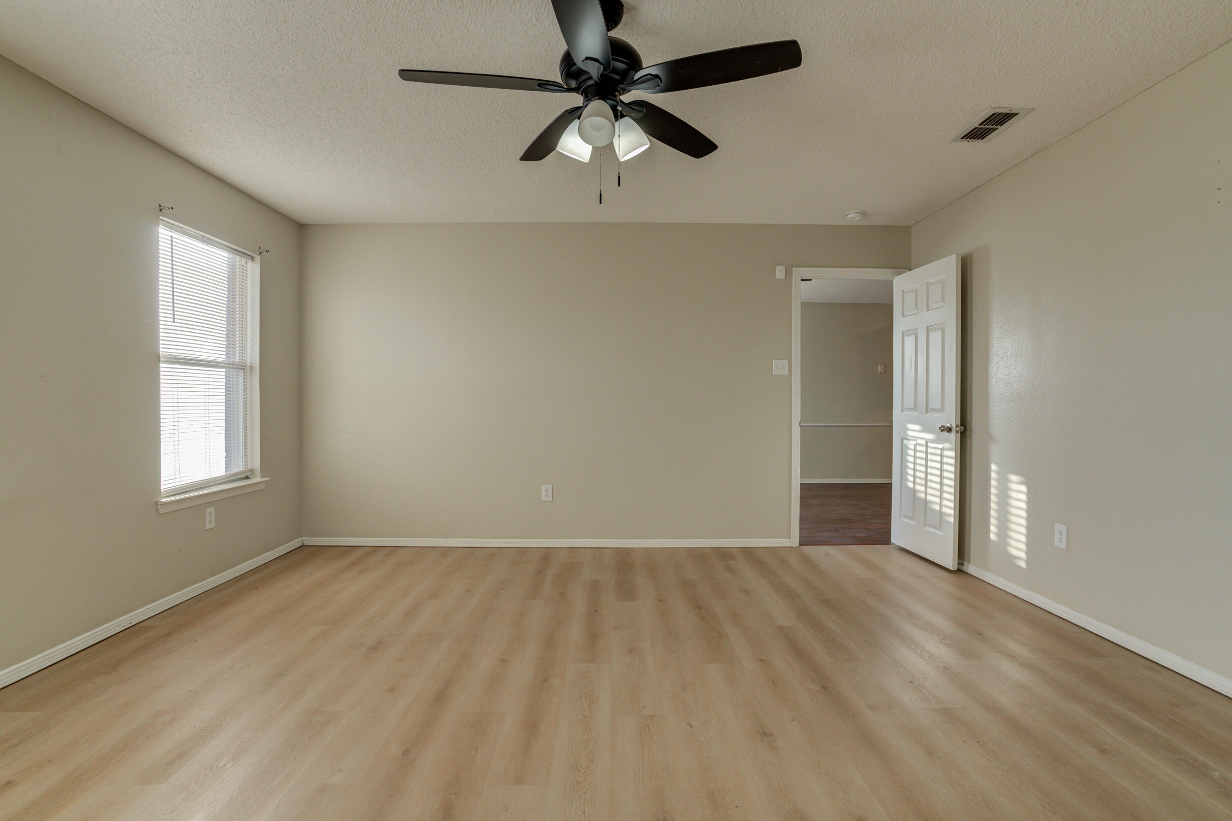 6221 18th Street Lubbock, TX 79416 - Photo 32 of 48 wooden floor in an empty room with a window