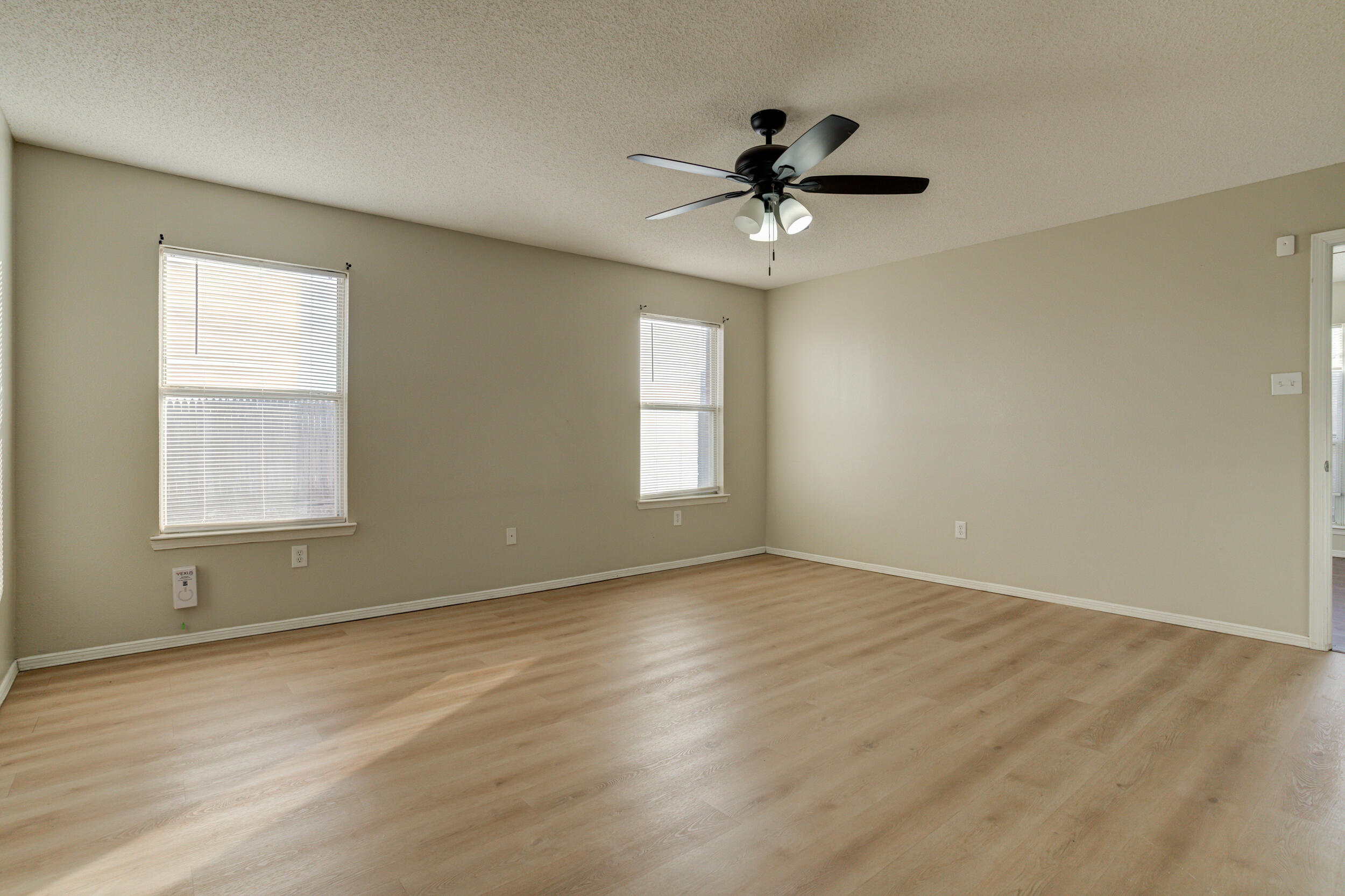 6221 18th Street Lubbock, TX 79416 - Photo 33 of 48 an empty room with wooden floor fan and windows