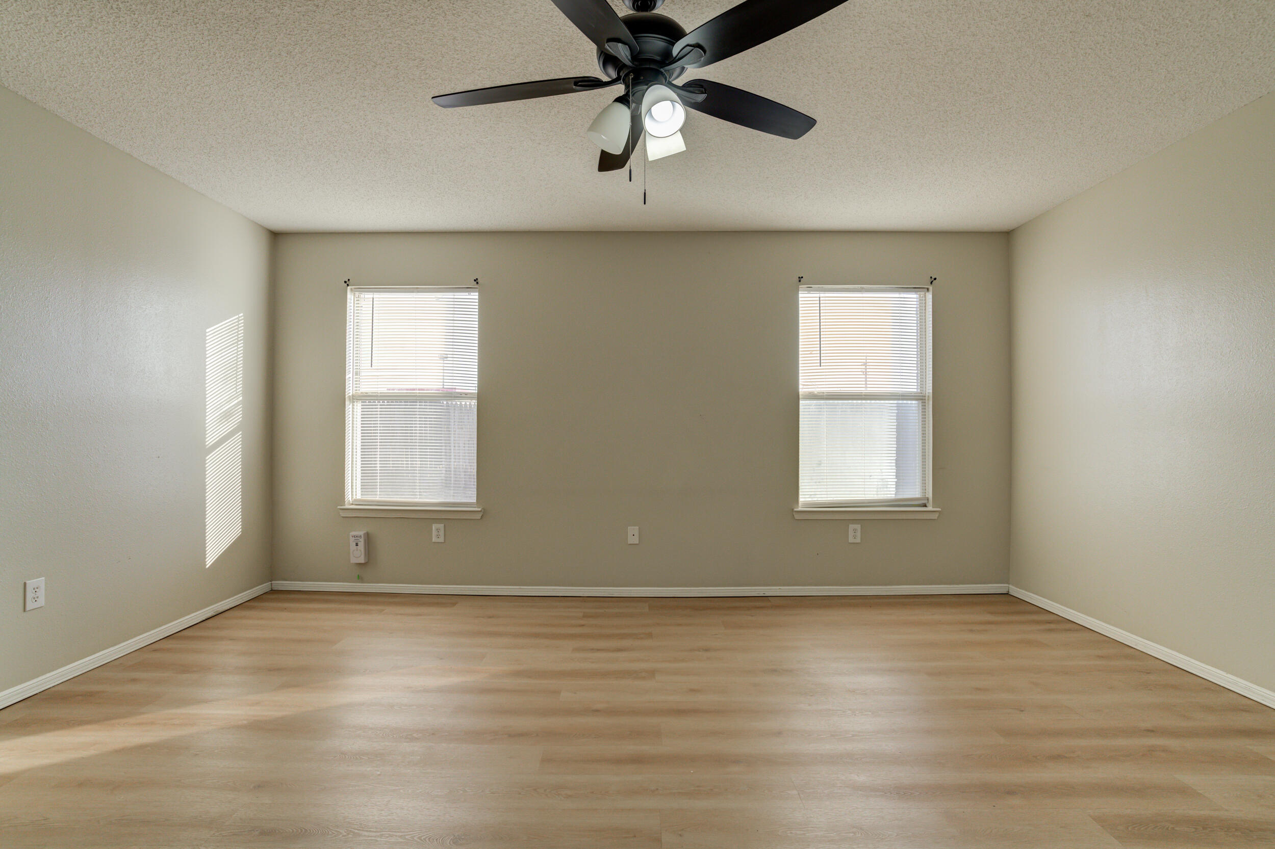 6221 18th Street Lubbock, TX 79416 - Photo 34 of 48 an empty room with a window and a ceiling fan