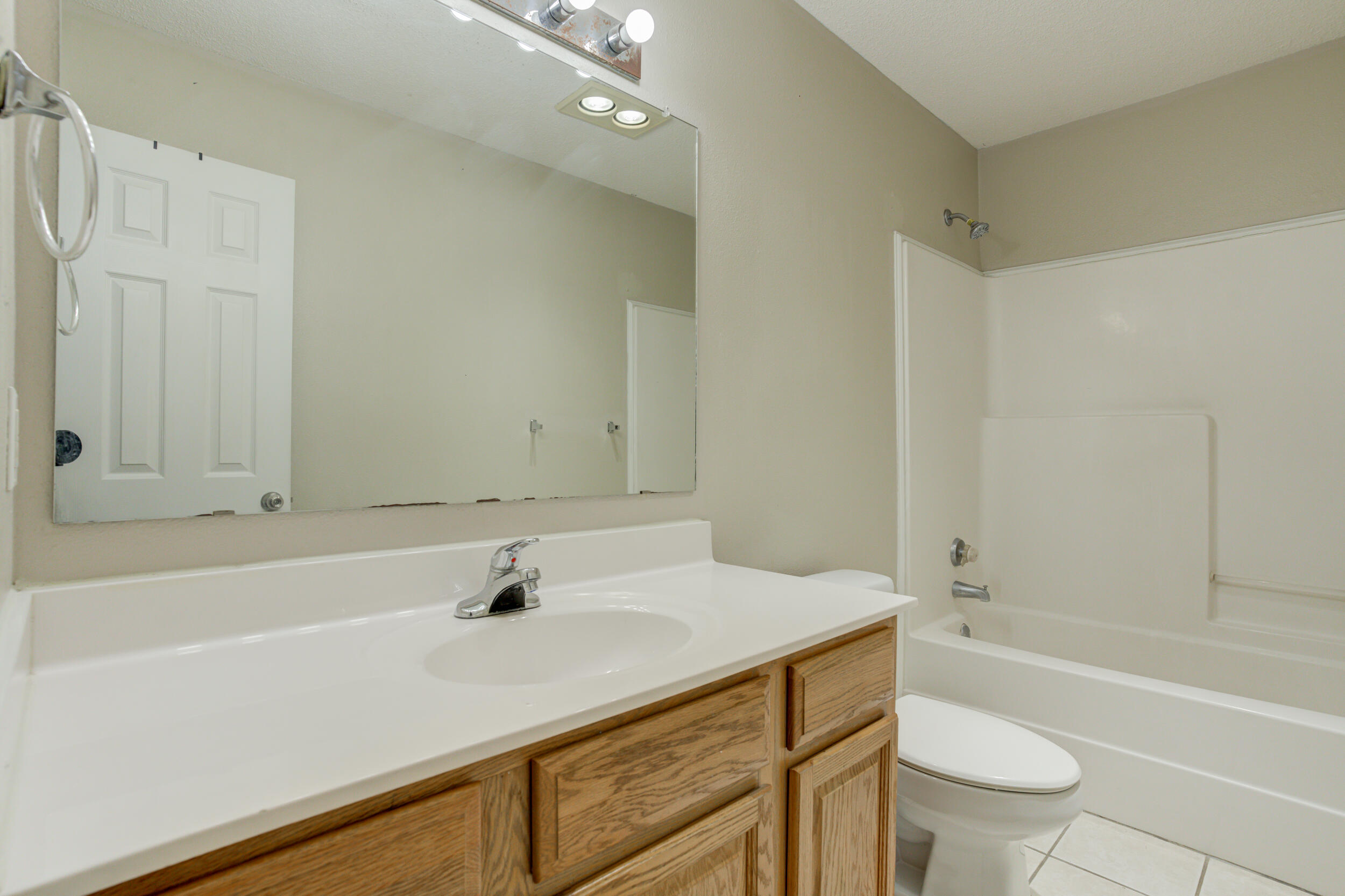 6221 18th Street Lubbock, TX 79416 - Photo 42 of 48 a bathroom with a sink a toilet and shower