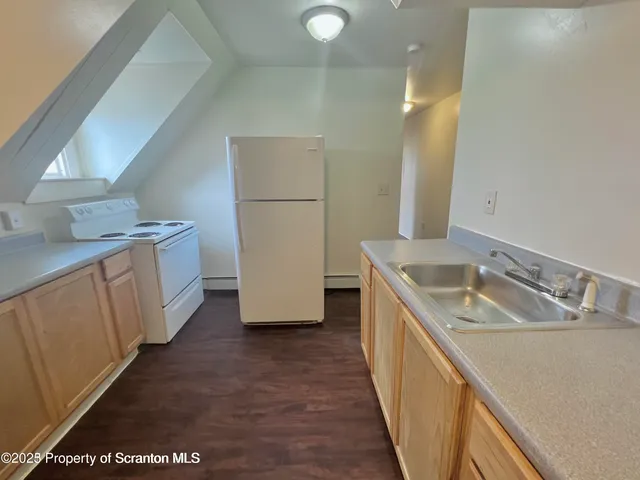 a kitchen with a sink stove and refrigerator