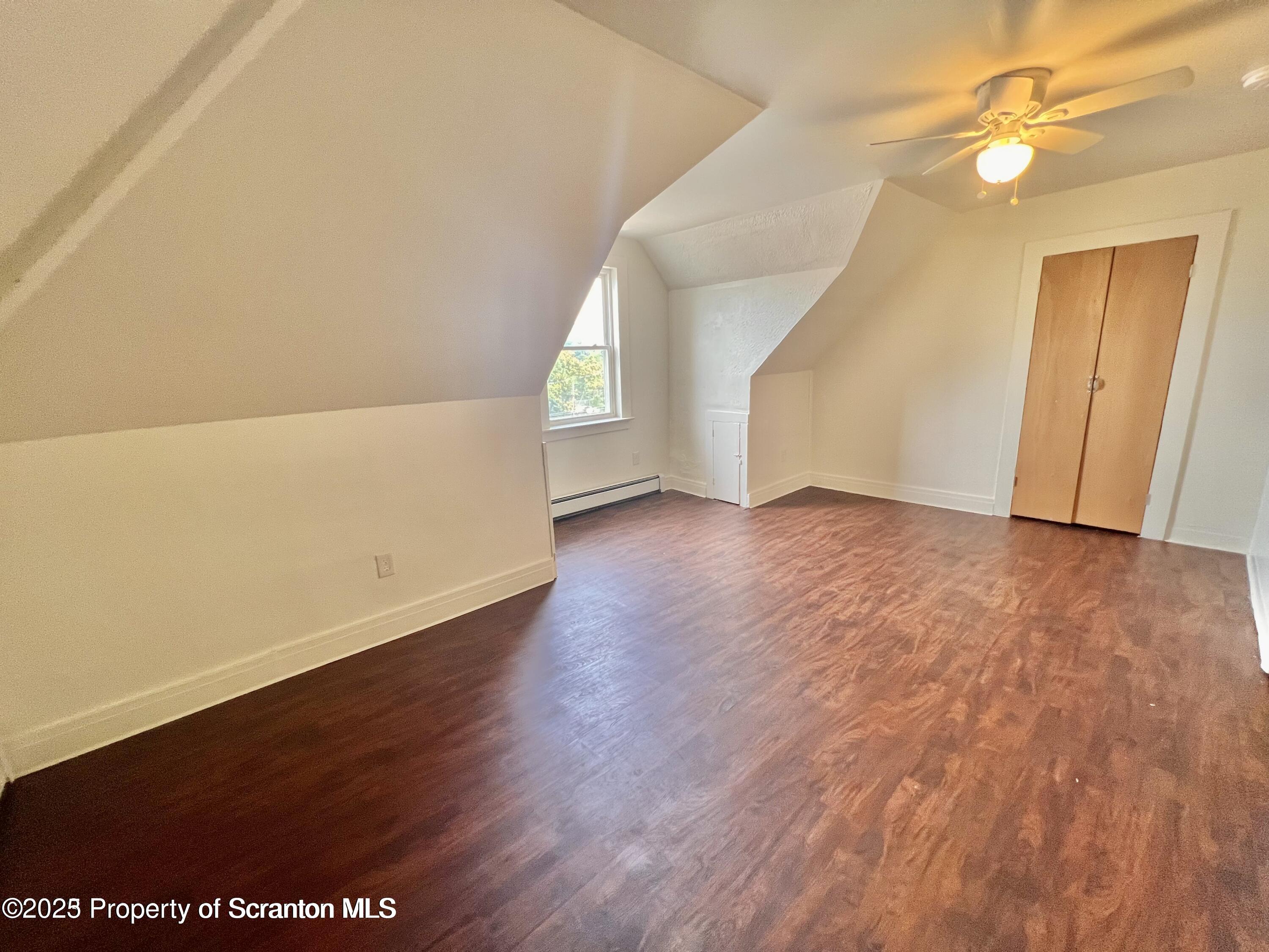 1930 Boulevard Avenue, Unit 3 Scranton, PA 18509 - Photo 6 of 8 an empty room with wooden floor and windows