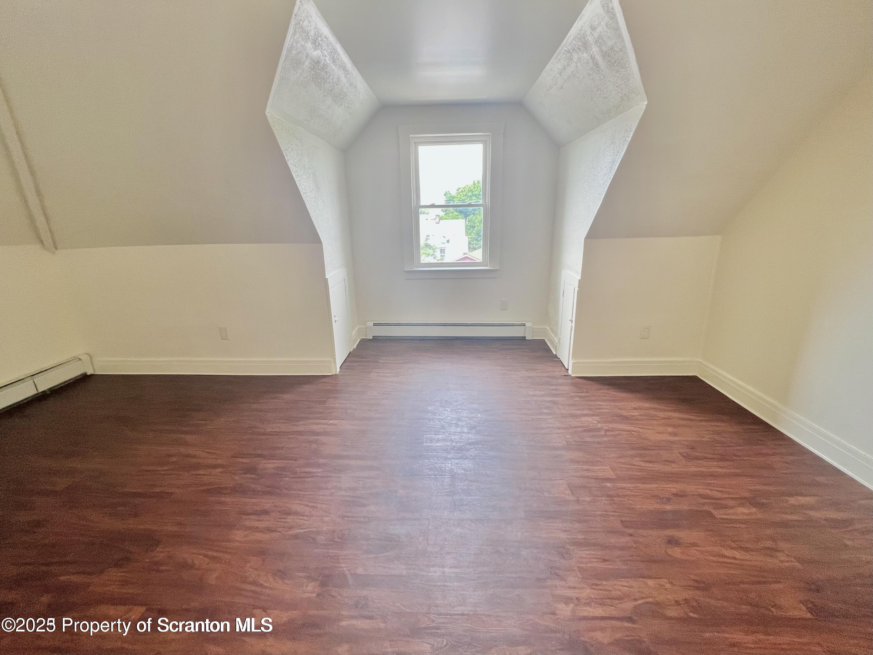 1930 Boulevard Avenue, Unit 3 Scranton, PA 18509 - Photo 8 of 8 an empty room with wooden floor and windows