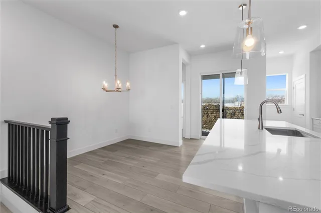 a view of empty room with wooden floor and ceiling fan