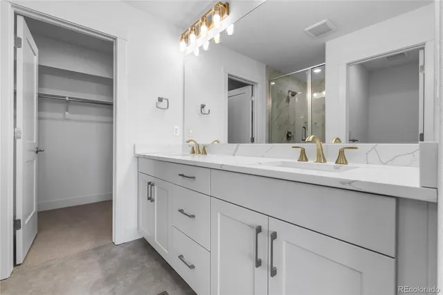 a bathroom with a granite countertop toilet a sink and a bathtub