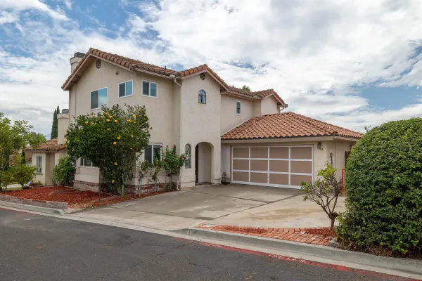 a view of a house with a yard and garage