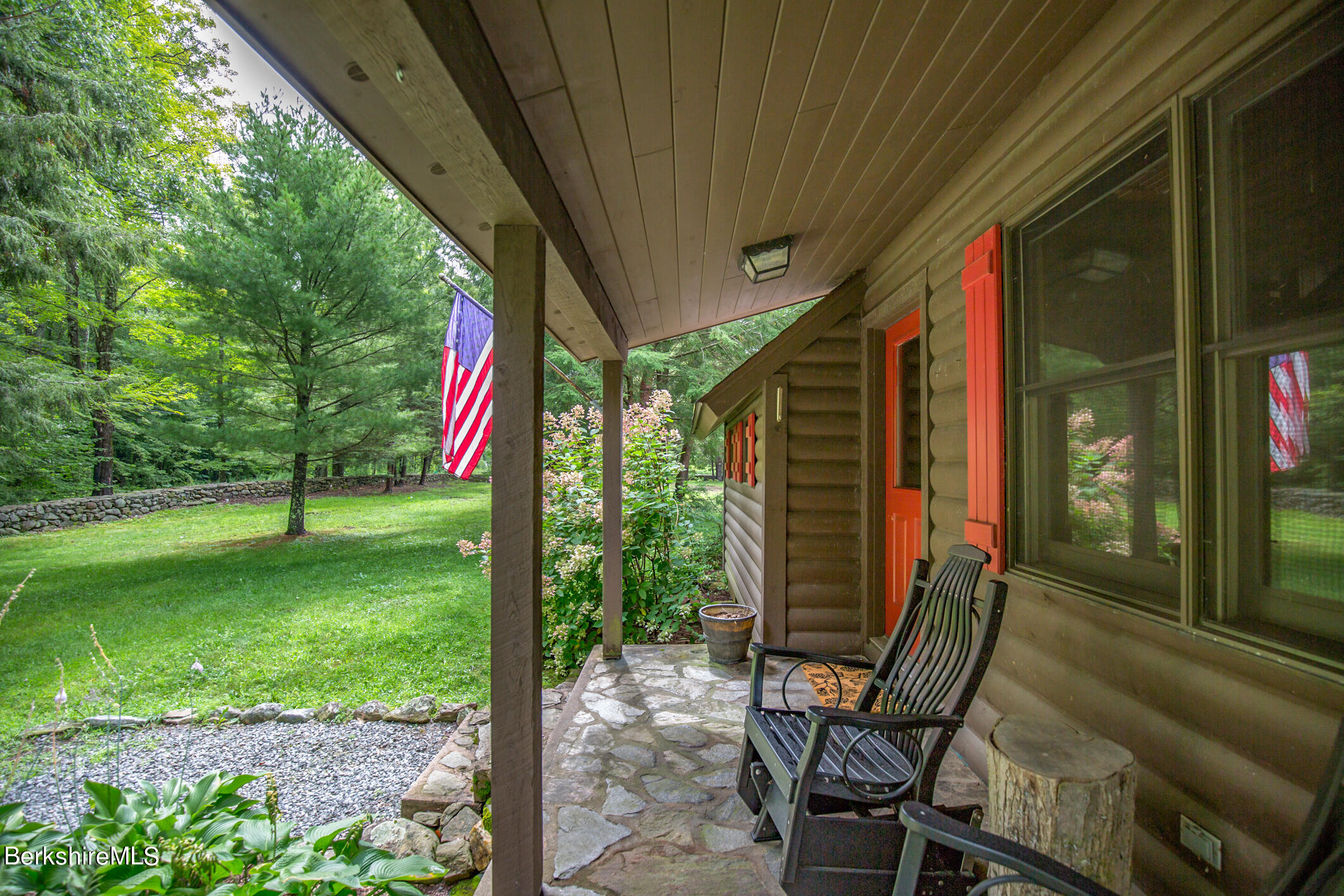 43 Becket Road Otis, MA 01029 - Photo 3 of 41 a view of a chair and tables in the patio in front of a house