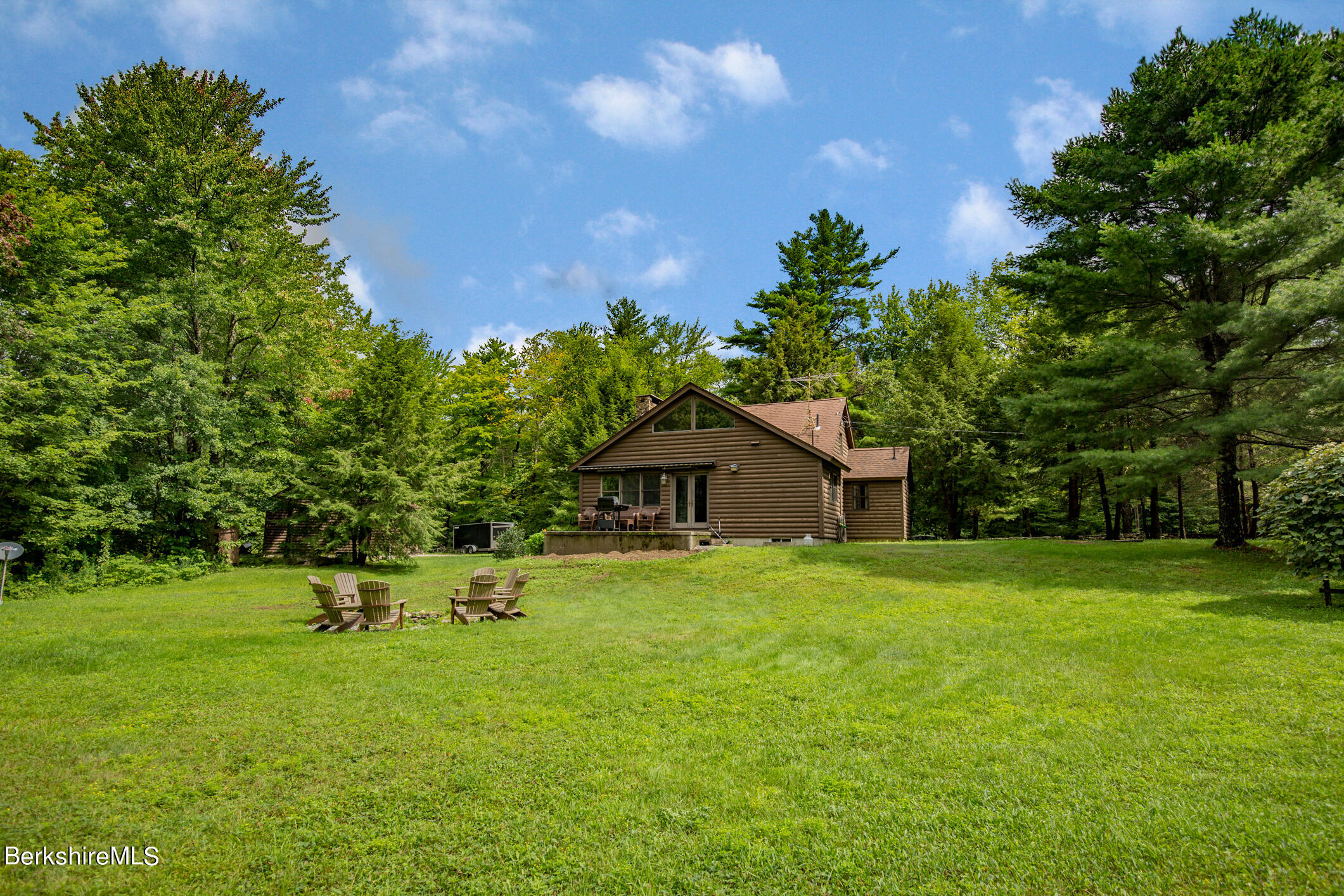 43 Becket Road Otis, MA 01029 - Photo 35 of 41 a house with a big yard and large trees