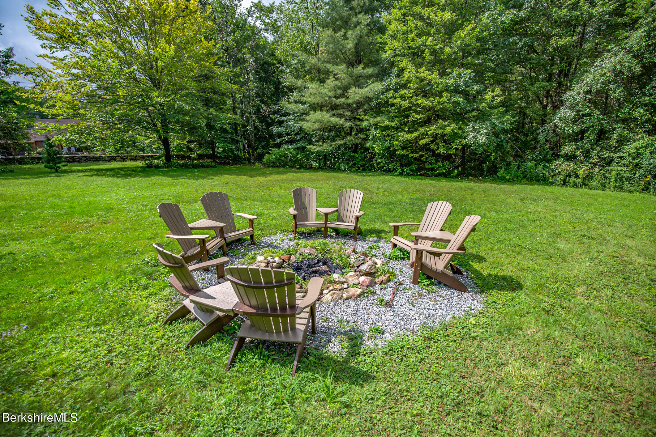 43 Becket Road Otis, MA 01029 - Photo 38 of 41 a backyard of a house with table and chairs